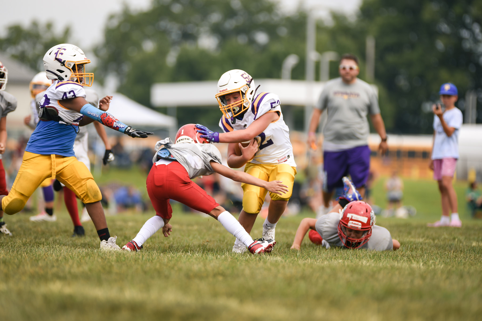 Player Number 52 stiff-arms another player